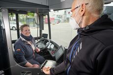 Busse erhalten Trennscheibe Fahrgast beim Einstieg in den Bus. Durch eine Trennscheibe sind Fahrerin und Fahrgast geschützt.