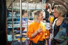 Zwei Frauen unterhalten sich an der Bar in der SparrenExpress-Partybahn.